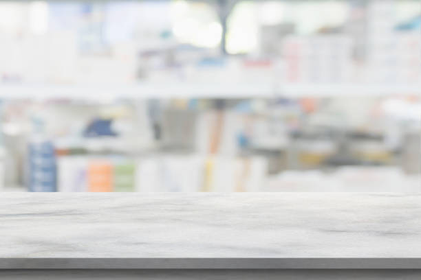 istock Empty white marble counter top with blur pharmacy drugstore shelves background 1385236279