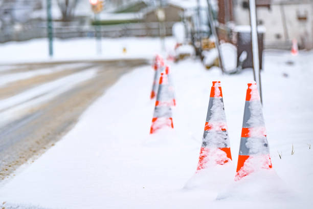 istock Street road work cones covered in snow, road work, construction 1385241678