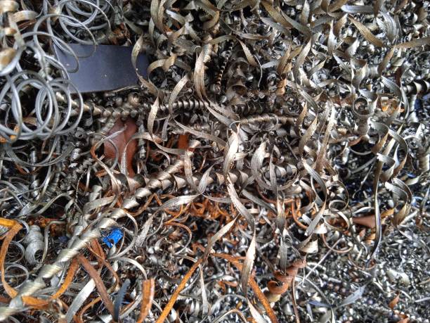 istock Pile of spiral iron waste from iron material produced from CNC machines 1385264414