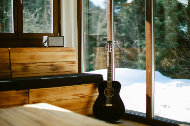 Guitar and a wireless speaker in the corner of the cozy mountain cabin.