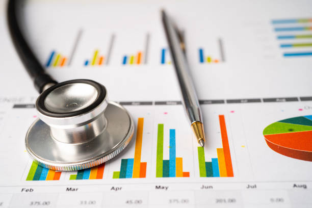istock Stethoscope with calculator on chart graph paper, finance, account, statistic, analytic economy Business concept. 1385274743