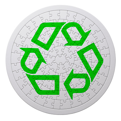 White jigsaw puzzle with green recycling symbol, isolated on white with clipping path.\nRecycling concepts.