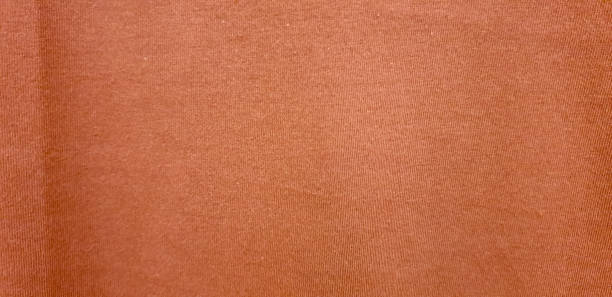 istock orange woven soft fabric texture. orange cotton background. copy space for image or text 1385276489