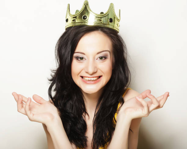 istock pretty brunette woman wearing crown 1385278225