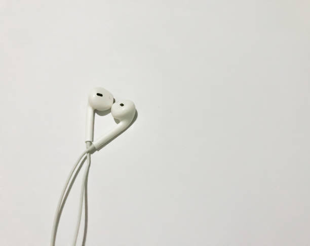 istock White earphone isolated on white background with copy space background . white modern headphones with a headset on a light gray background. concept of digital music 1385279160