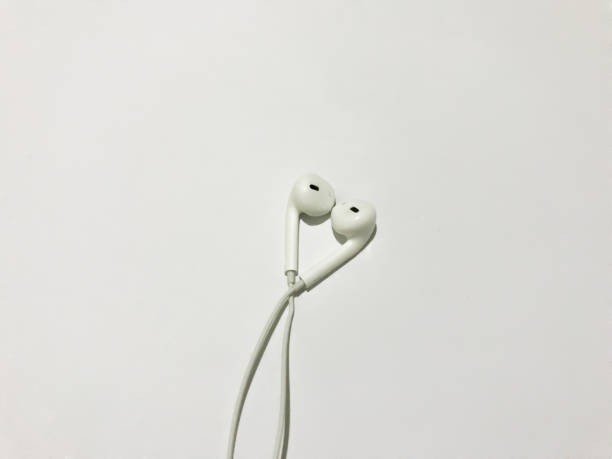 istock White earphone isolated on white background with copy space background . white modern headphones with a headset on a light gray background. concept of digital music 1385279164