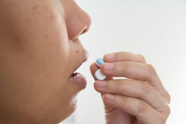 istock Pills to reduce fever in hand 1385279240