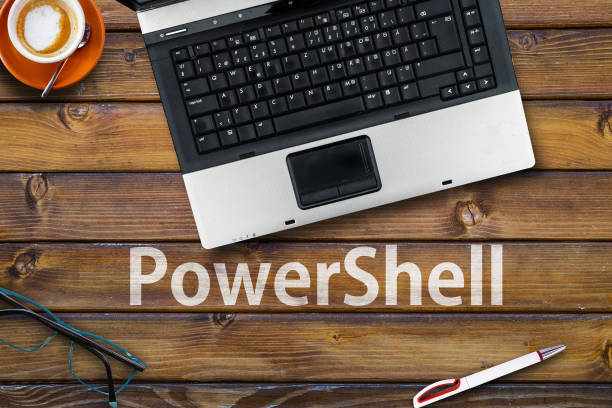 istock Word PowerShel and laptop, glasses and coffee on wooden table 1385282053