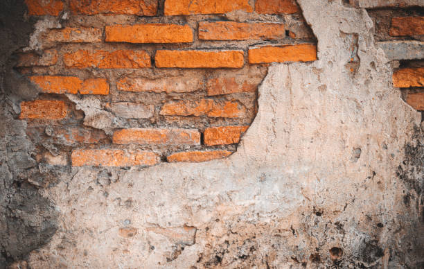 istock red brick block wall texture old background ancient weathered brick wall with cracks and destroyed stucco layer with copy space 1385283493