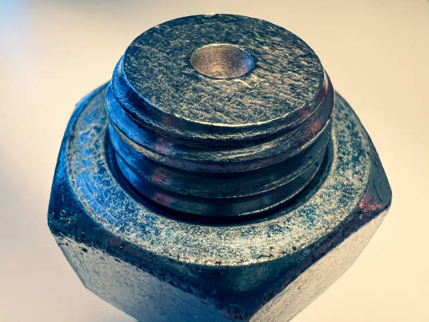 istock A large, used screw with nut on a white background. 1385289742