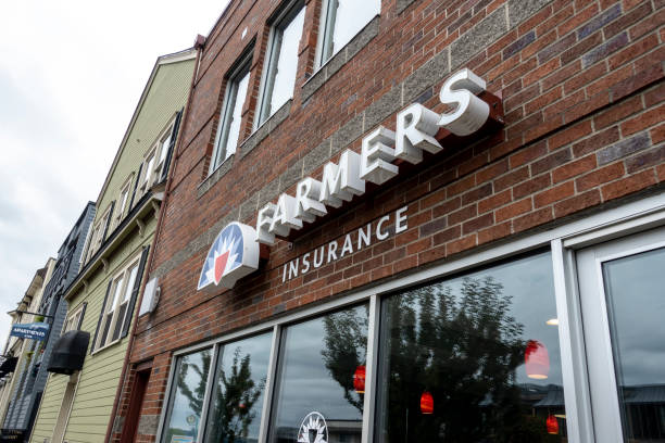 vista ad angolo basso di un edificio farmers insurance nella storica zona della città vecchia di tacoma in una giornata nuvolosa. - open foto e immagini stock