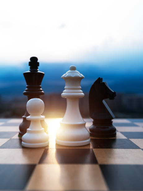 istock Black and white chess pieces on chess board 1385299437