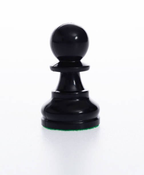 Wooden black pawn on a chessboard. Chess pieces, side view