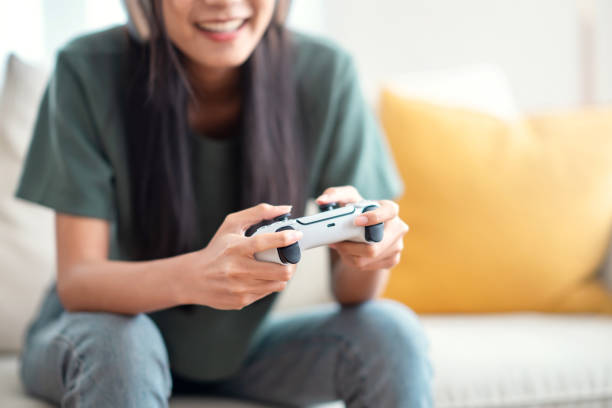 Woman hand playing a computer games with joystick stock photo