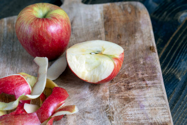 istock cutting old board with pieces of red ripe apple 1385301117
