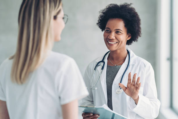 istock Smiling female doctor talking to a nurse 1385306768
