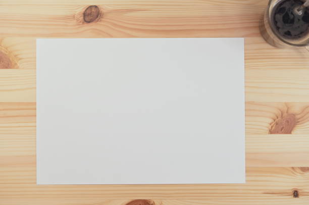 istock white paper on wood table with coffee 1385308004