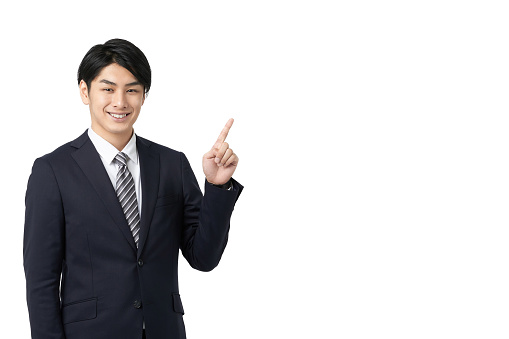 Asian businessman pointing with a smile