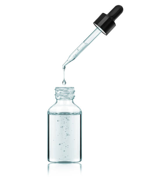 istock Stretched drop drips from a pipette in bottle isolated on a white background 1385309063