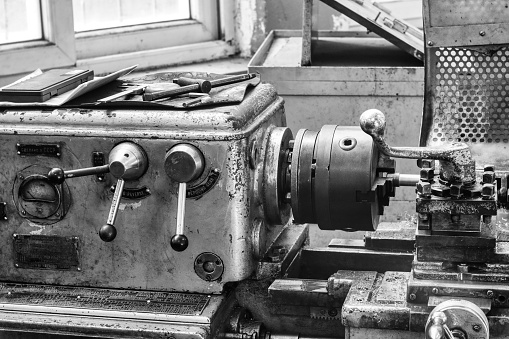 Old lathe - Industrial machines in a old factory - black and white photo