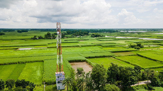 Aerial view of mobile network tower in a village of Bangladesh. Cellular communication tower for mobile phone 4G 5G network signal