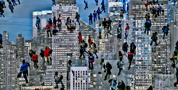 Shot of unrecognizable people climbing on skyscrapers superimposed over an illuminated cityscape. The city is NYC, Manhattan.