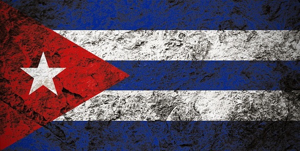 Republic of Cuba flag on grunge stone background