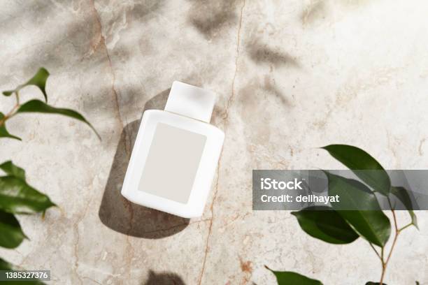 Face Or Body Care Cosmetic Product Bottle With Blank Label On Marble Stock Photo - Download Image Now