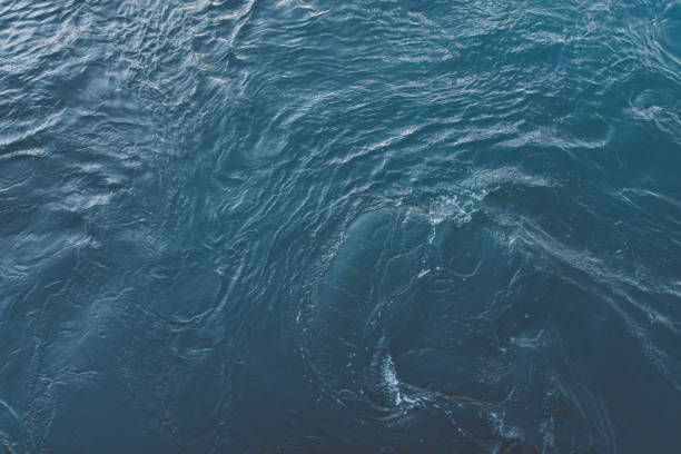 istock Blue sea surface with waves and ripples. Top view 1385327595