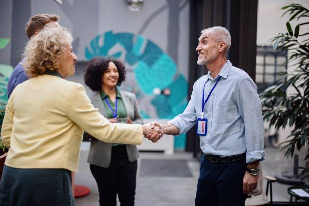 istock Business people greet each other during a coffee break at a conference 1385328396
