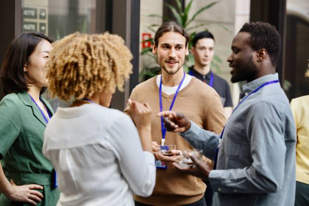 Business professionals having a casual chat after successful conference event