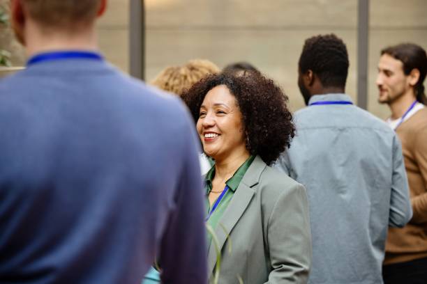 istock Business professionals attending business conference, networking, busy, discussion, collaboration 1385328449