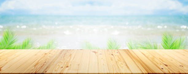 istock Table on sea with palm leaves background. 1385328576