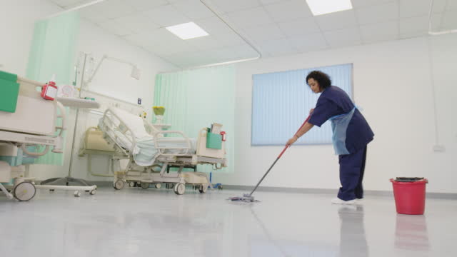Orderly mopping hospital floor