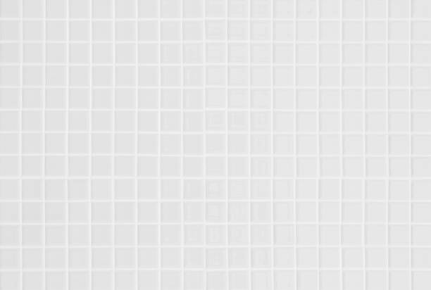 istock White ceramic wall and floor tile abstract background. Design geometric gray mosaic texture decoration of the bedroom. Simple seamless pattern grid for backdrop hospital wall, canteen and kitchen. 1385332997
