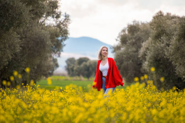 Beautiful Woman Walking Among Flowers