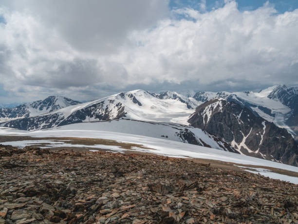 istock Bright atmospheric scenery on top of mountain ridge above clouds in thick low clouds. Beautiful landscape with mountain range with sunlight under dense clouds. 1385336584