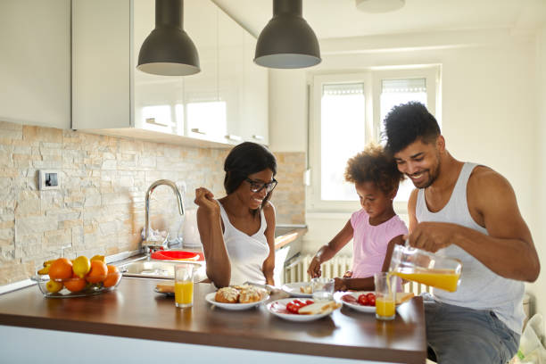 istock Young happy family having breakfast at home 1385340657