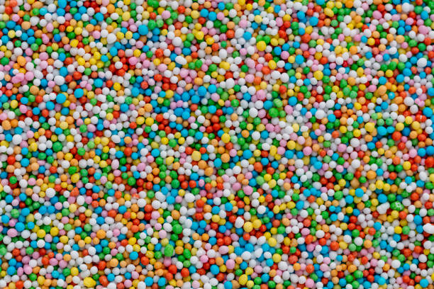 istock Thousands sprinkles tiny sugar beads for decorating cakes and desserts background. 1385341045