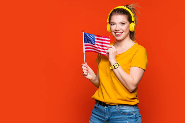 istock Girl holds small USA flag 1385341146