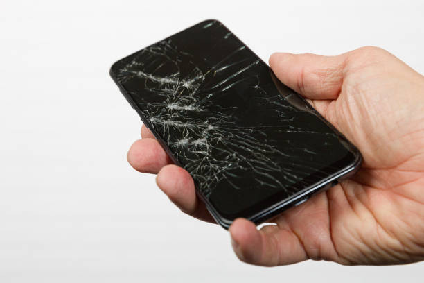 istock Hand presents a smart phone with cracked display 1385341649
