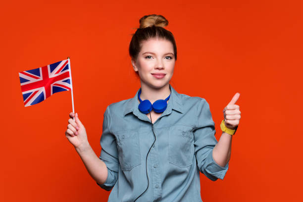 Girl holds small national flag of UK. stock photo