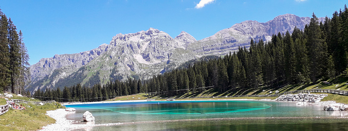 Lake Montagnoli and beautiful panoramic view of the mountains in Trentino, travel and landscapes in the Adamello-Brenta park in Italy