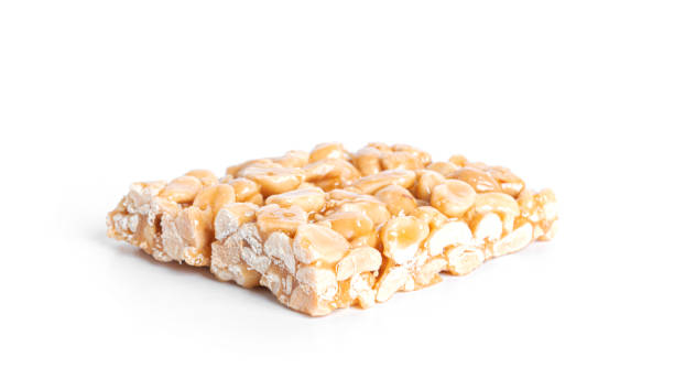 istock Peanut brittle isolated on white background. Peanuts in caramel. Natural candy bar 1385342964