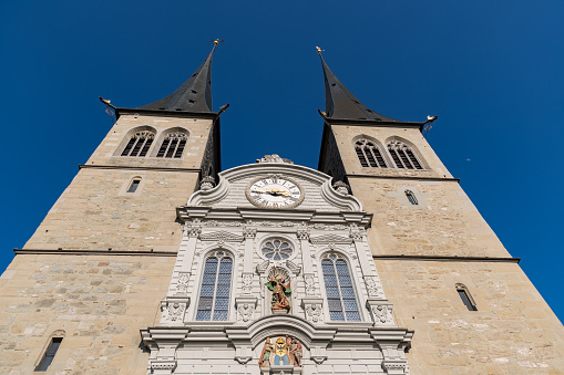 Lucerne, Switzerland, March 10, 2022 Towers of the holy saint Leodegar chuch on a sunny day