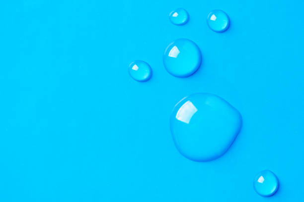 istock Water drops on blue background. Abstract drops of gel. 1385363670