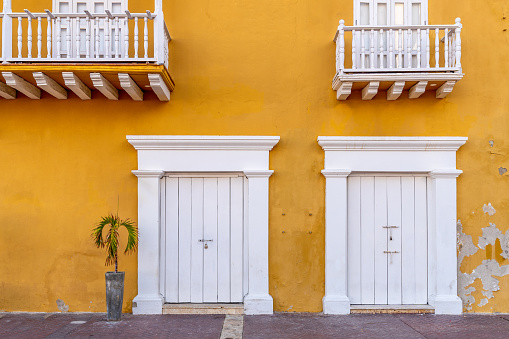 Old yellow building , white doors and window,background