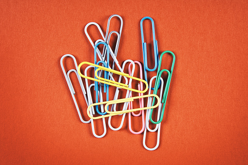 Paperclips on a brightly colored background.