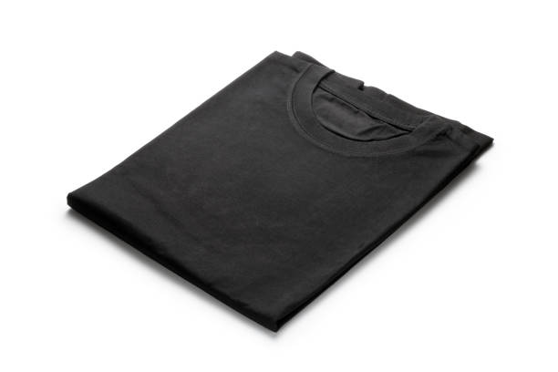 Black folded t-shirt Black folded t-shirt isolated on white background. folded stock pictures, royalty-free photos & images