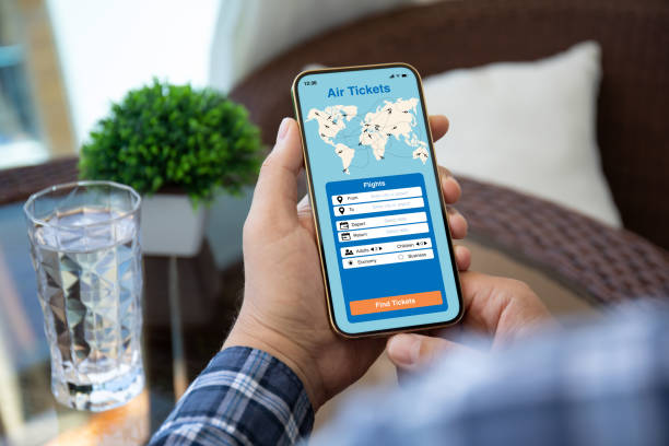 istock man hand holds phone with application searching air tickets 1385373472